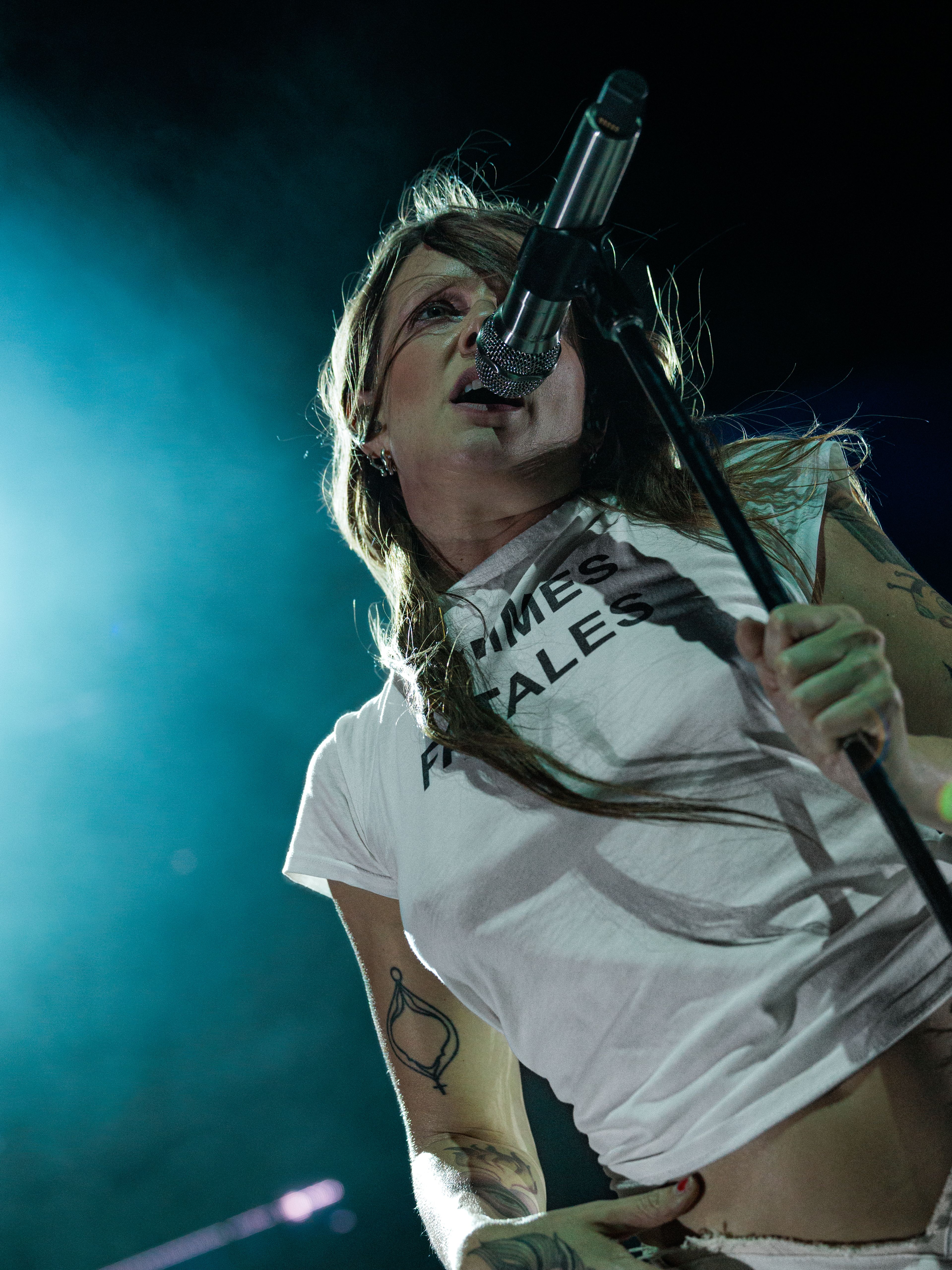 Tove Lo performs beneath bright multicolored beams of stage light during her Los Angeles concert.