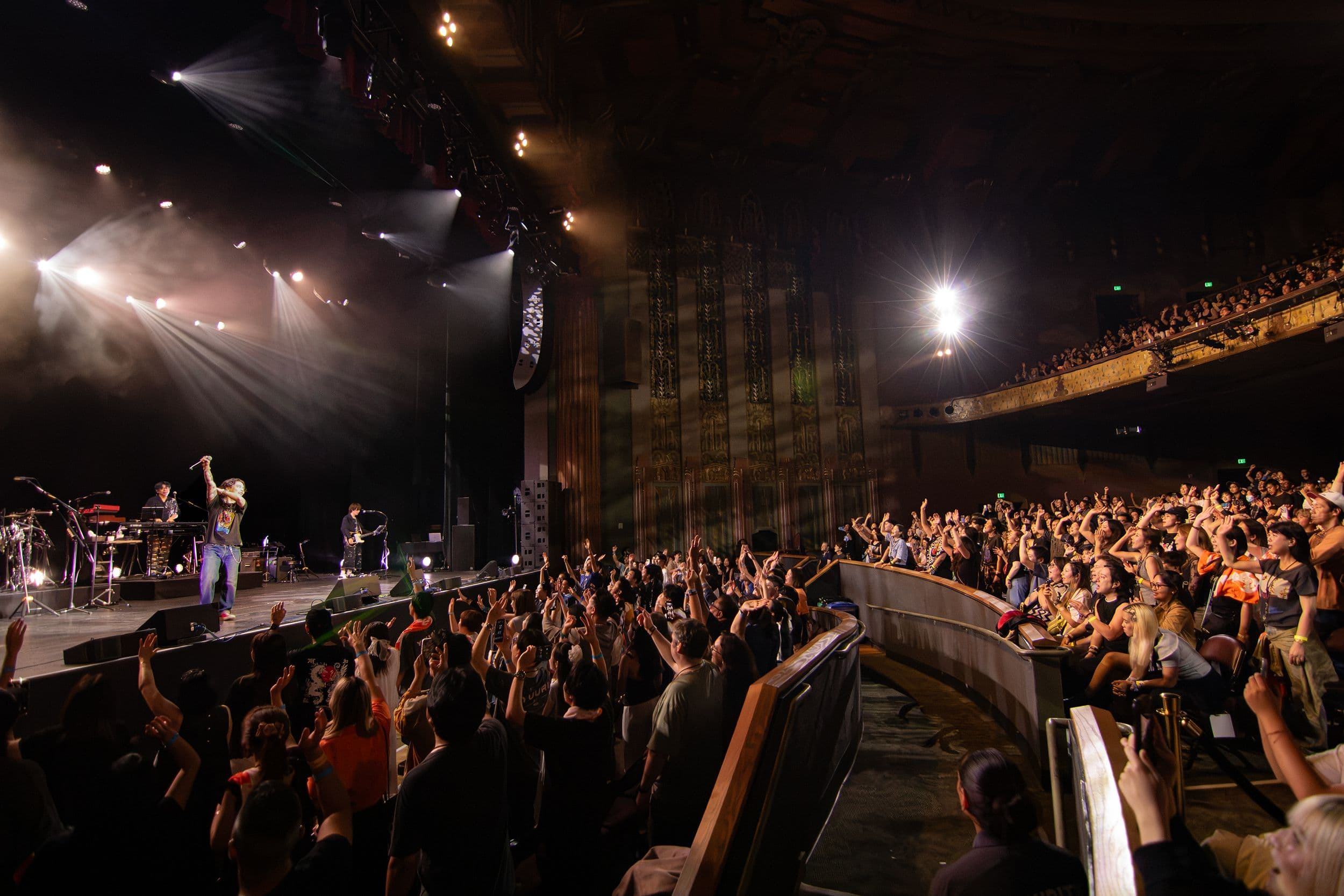 Yuuri performs onstage at The Wiltern as the Los Angeles crowd raises its hands toward him.