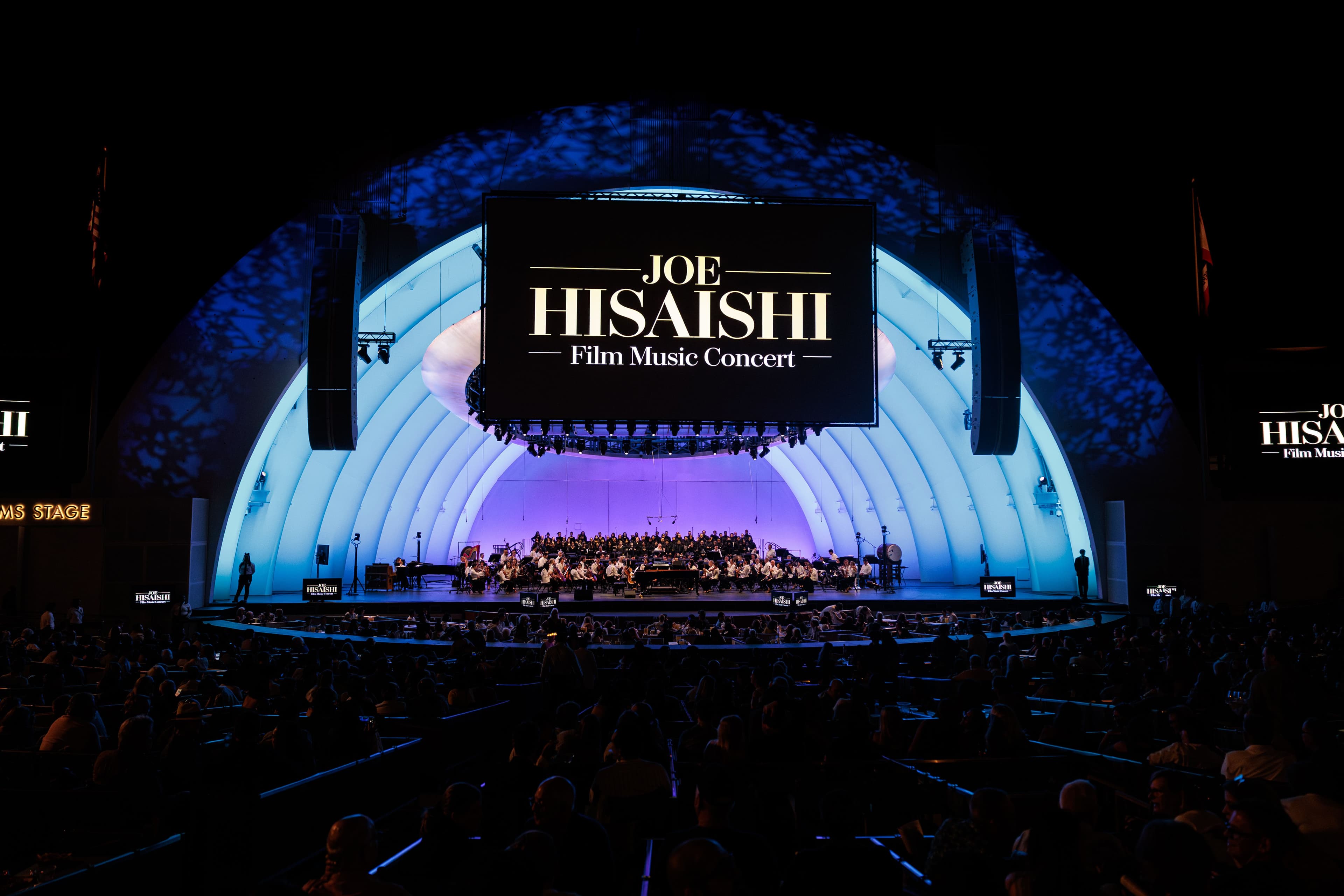 The Hollywood Bowl glows blue and lavender beneath a screen reading “Joe Hisaishi Film Music Concert