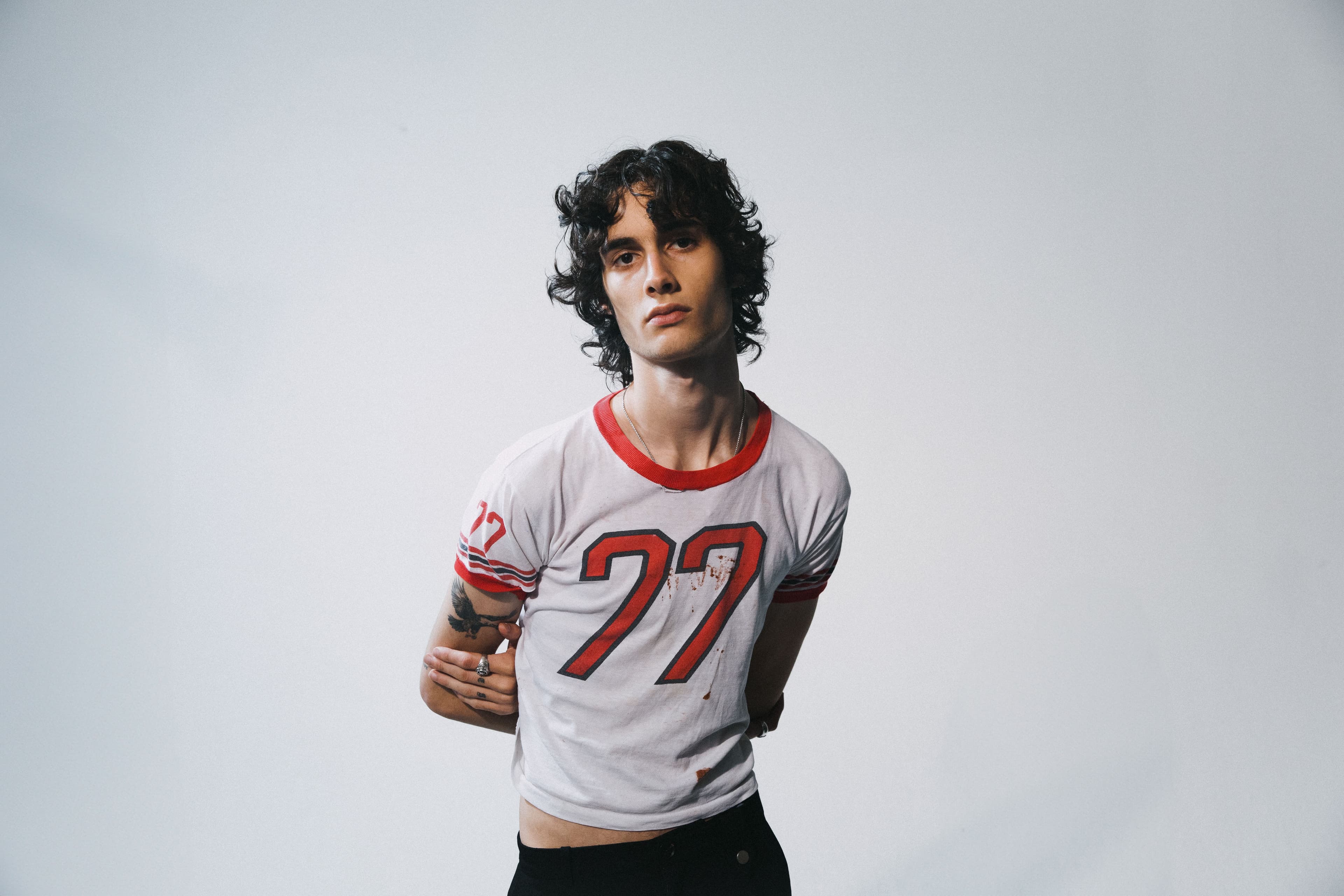 sombr poses for an official press portrait.